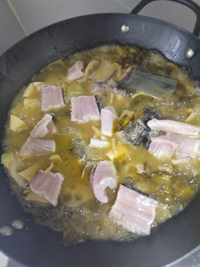 Snakehead spine and thick meat pieces simmering in broth